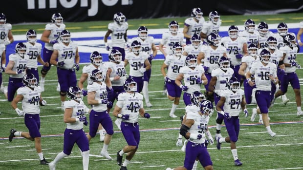 Northwestern Wildcats players take the field prior to the Big Ten Championship football game against the Ohio State Buckeyes at Lucas Oil Stadium in Indianapolis on Saturday, Dec. 19, 2020. Adam Cairns/Columbus Dispatch
